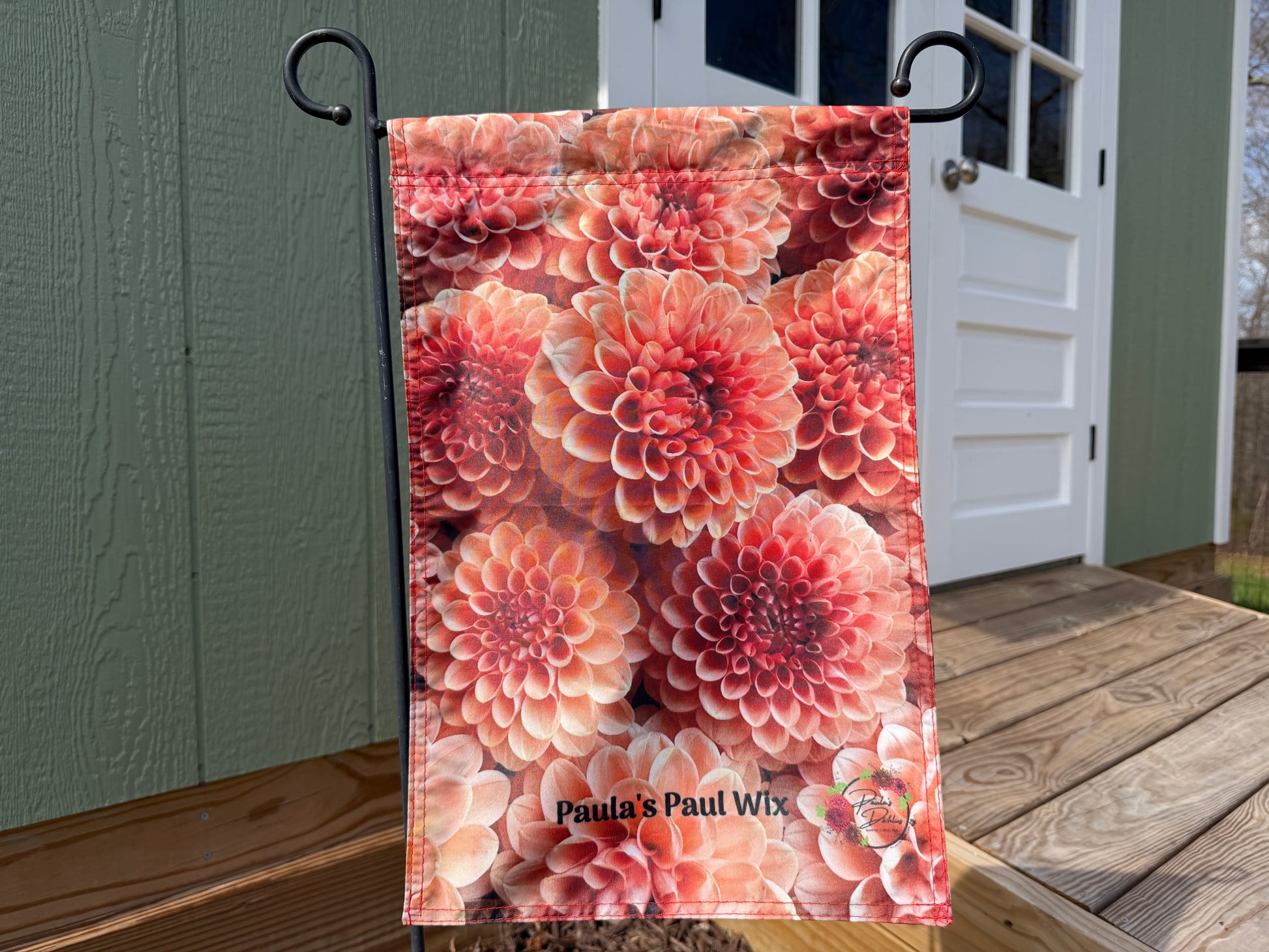Pink flowers on a garden flag of Paula's Paul Wix dahlias